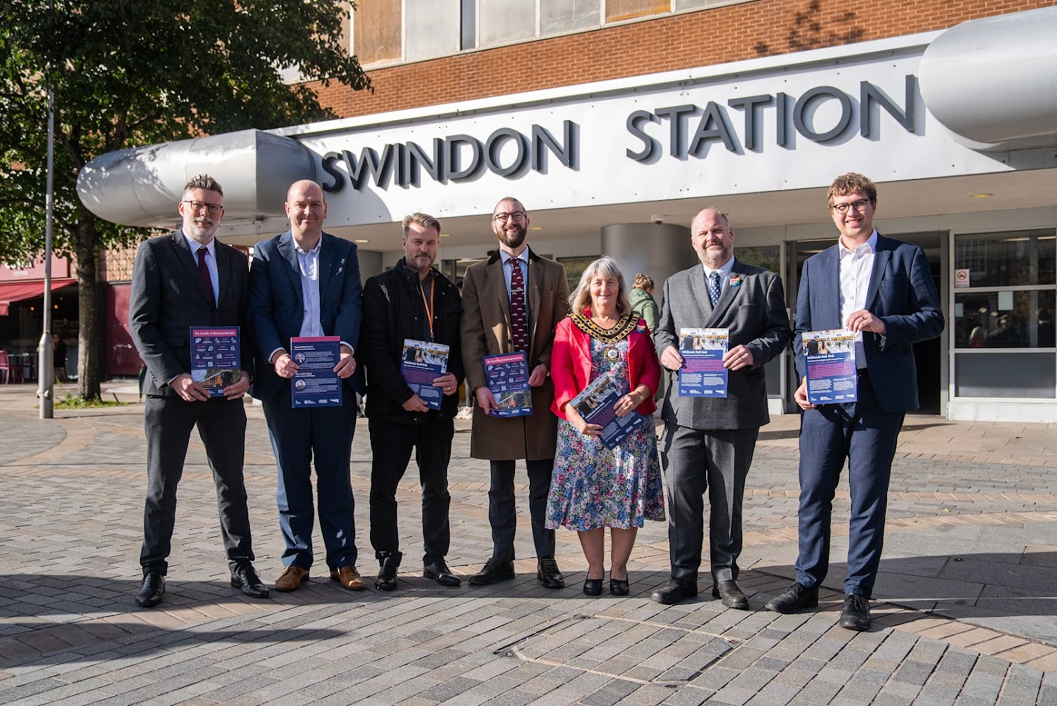 seven people stood outside Swindon rail station